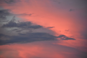 Dark clouds in an orange colored sky before rain