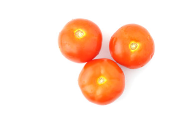 Three red tomatoes isolated on white background