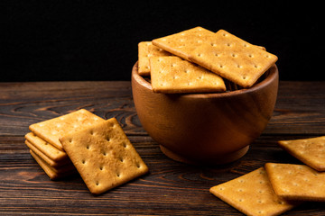 Cracker cookies with onion dark wooden background.