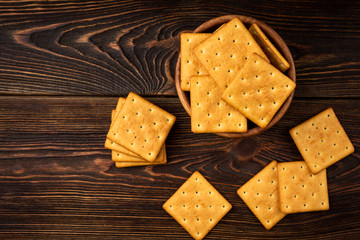 Cracker cookies with onion dark wooden background.