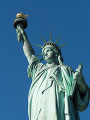 The Statue of Liberty figure, in her left hand carrying a tablet with dovetail handles