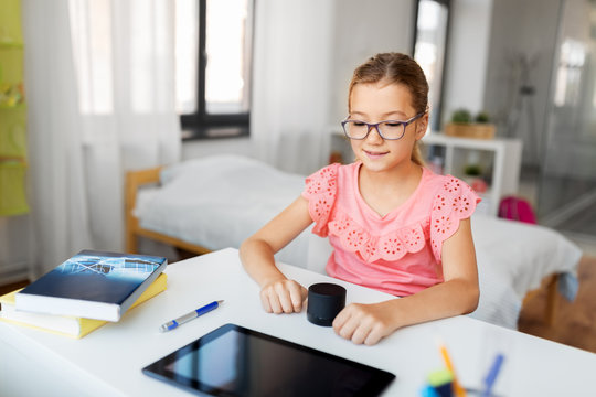 Children, Education And Technology Concept - Student Girl Using Smart Speaker At Home