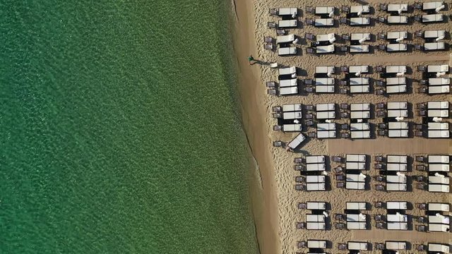 Aerial drone view video of iconic sandy bay and turquoise beach of Paliouri in Kassandra Peninsula, Halkidiki, North Greece