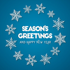 Season's Greetings and Happy New Year concept. Abstract wreath made of white snowflakes on blue background © lvnl