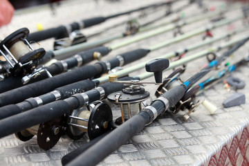 Collection of sea boat fishing rods and reels on a charter boat
