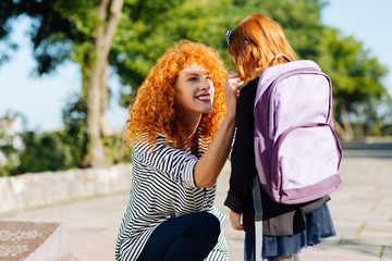 Fototapeta premium Amazing pupil communicating with her mom before school