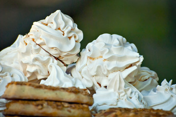Multicolored round sweets at the shop window. Many cakes on a shelf.