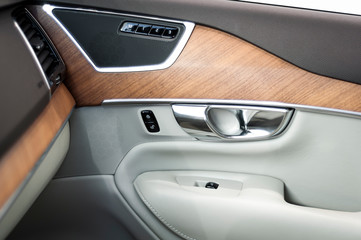 Door handle with Power seat control buttons of a luxury passenger car.