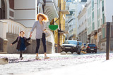 Active mother and kid crossing the street