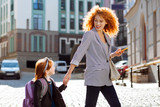 Positive delighted red haired woman looking at her child