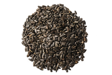 Seeds in a black shell are a bunch on a white background. In full screen