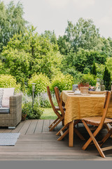 Elegant garden furniture on terrace of suburban home