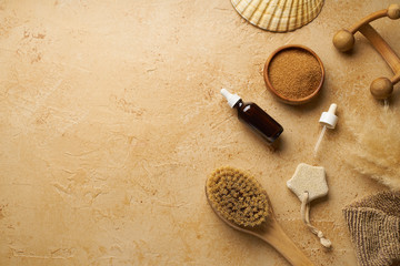 Fototapeta na wymiar Spa beauty skincare flatlay with organic body brush and accessories on travertine background. Overhead view, copy space