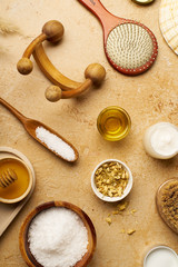Spa beauty skincare flatlay on travertine background. Body brush, serum and ingredients for scrubs. View from above, copy space