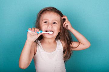 Cute little girl brushing her teeth