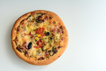 Round pizza on a white background. Concept - Italian cuisine. Copy space
