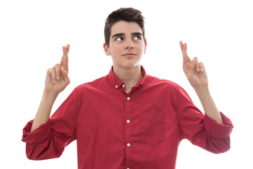 young boy with fingers crossed isolated on white