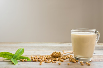 Soy milk and soy bean it on wood table background,healthy concept. Benefits of Soy.