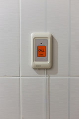 Pulling of red emergency call alert in the hospital toilet