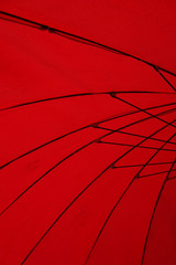 structure under bright red umbrella in city.