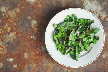 mix salad leaves in a plate (fresh green snack). food background. top