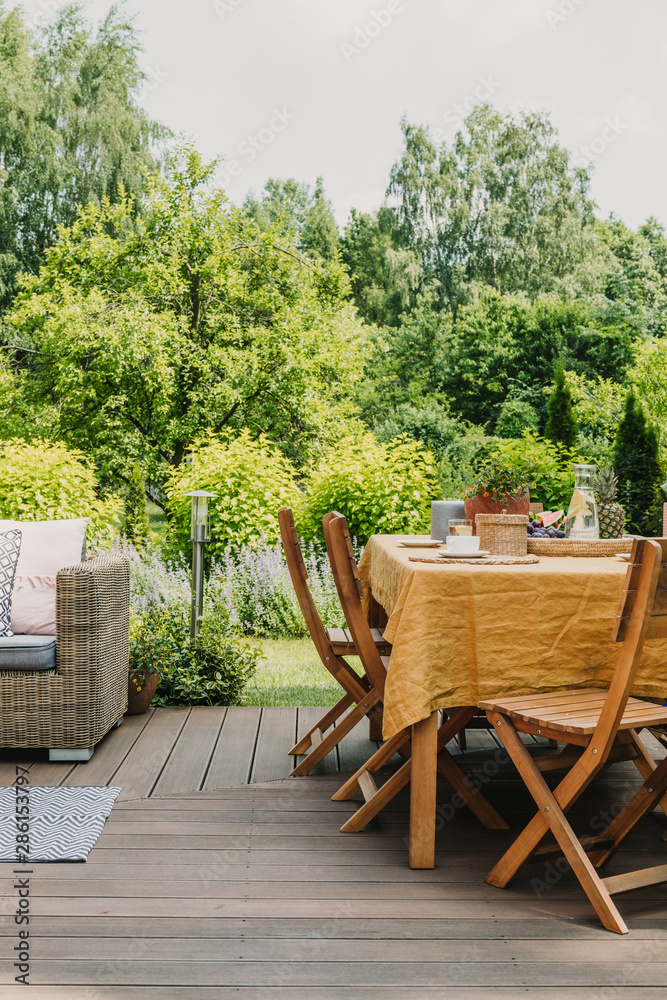 Wall mural elegant garden furniture on terrace of suburban home