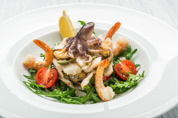 salad of seafood and vegetables with arugula and tomatoes
