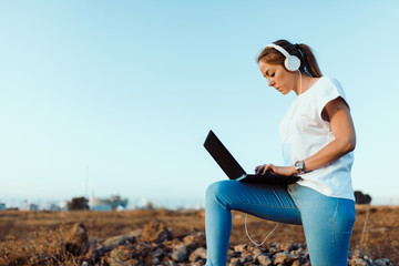 Young woman with her laptop listened external communications