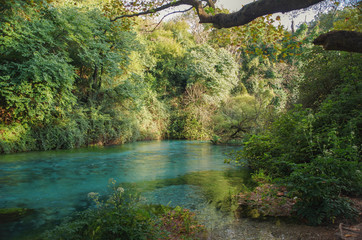 Autumn evening. Blue Eye Nature Monument. Water spring and natural phenomenon, clear blue water of...