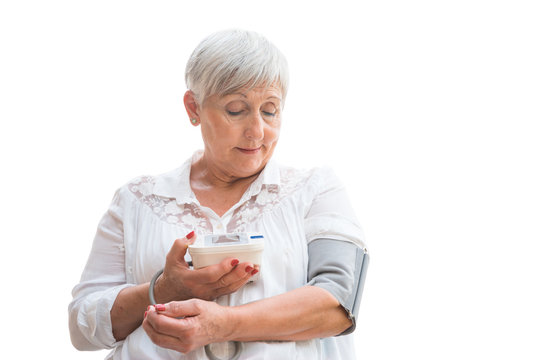 Senior Woman With White Hair And White Shirt Taking Blood Pressure