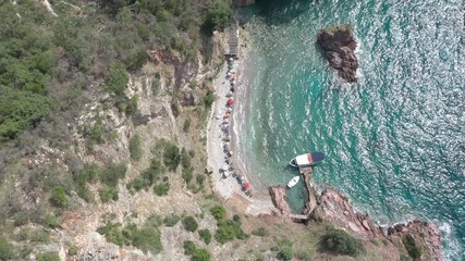 Drone flies above the coastline of the Adriatic sea, southern Montenegro, in a sunny summer day. Water in the sea is turquoise, clean and clear