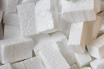 Heap of many rectangular pieces of styrofoam for packing parcels. Close-up. Background