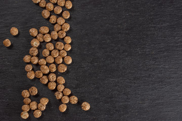Lot of whole chocolate ball breakfast cereals copyspace on right flatlay on grey stone
