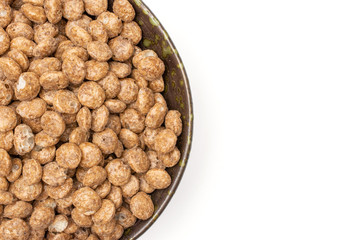 Lot of whole chocolate ball breakfast cereals on grey ceramic plate flatlay isolated on white background