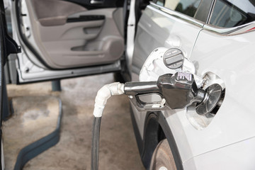 Filling A Vehicle’s Fuel Tank At A Gas Station