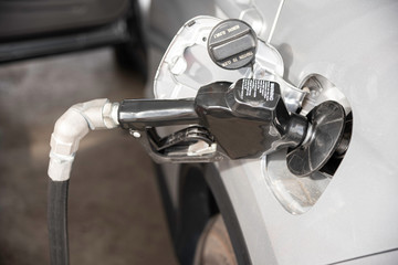 Obraz premium Filling A Vehicle’s Fuel Tank At A Gas Station