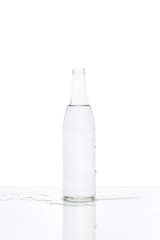 Glass water bottle on white background.
