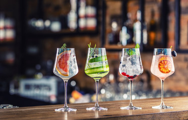 Gin tonic cocktails in wine glasses on bar counter in pup or restaurant