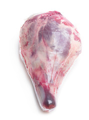 Vacuum pack of raw lamb leg isolated on white