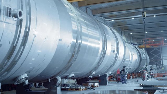 Industry Manufacturing Facility / Factory where Large Diameter Pipe is Being Assembled. Modern Industrial Manufacturing Technology to Design and Construct Transport Pipeline. Moving Dolly Camera Shot