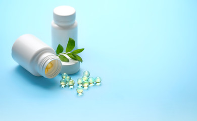 Assorted pharmaceutical medicine tablet, capsules and fresh green plant. medicine pill, vitamin supplement, Medical drug. concept organic preparations. close up. shallow depth, soft focus