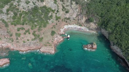 Drone flies above the coastline of the Adriatic sea, southern Montenegro, in a sunny summer day. Water in the sea is turquoise, clean and clear