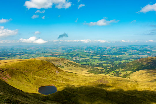 Brecon Beacons landscape view to the north from Corn Du peak during a sunny day with Llyn Cwm Lwch lake in the bottom left part of the picture