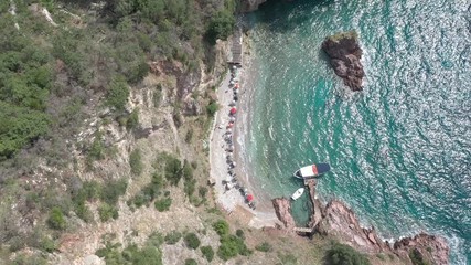 Drone flies above the coastline of the Adriatic sea, southern Montenegro, in a sunny summer day. Water in the sea is turquoise, clean and clear