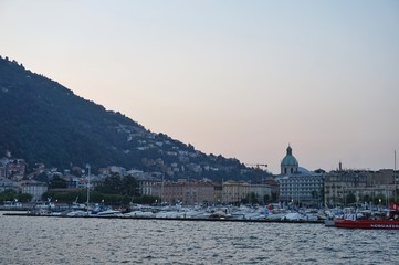 The sun rises over the Alps and the city of Como.