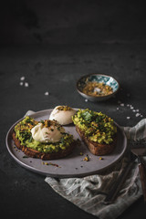 Poached egg on top of the sourdough toast with smashed avocado and dukkah spice
