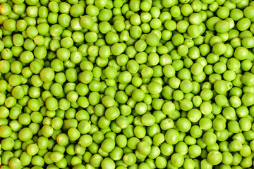 Natural background of many fresh organic green peas, top view