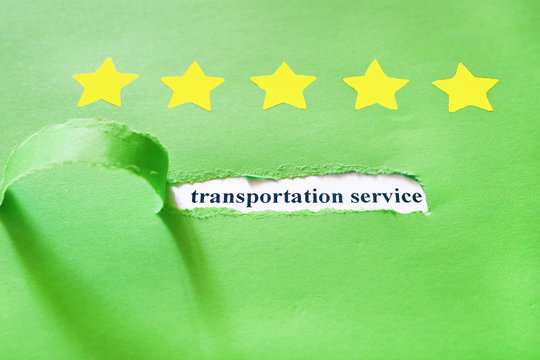 Oblong torn hole from right to left in green sheet of paper with shadow and paper curl. White resulting background with words TRANSPORTATION SERVICE. Yellow stars. Review concept. Copy space