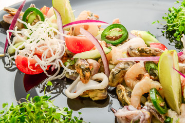 Thai spicy and sour seafood salad on a wooden table