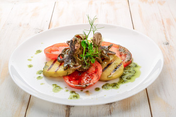 Grilled octopus on a plate.,grilled octopus with grilled vegetables
